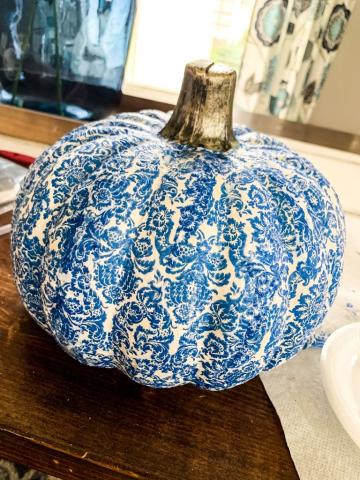 Image of the craft featuring a pumpkin shaped decoration with a decoupaged intricate design.