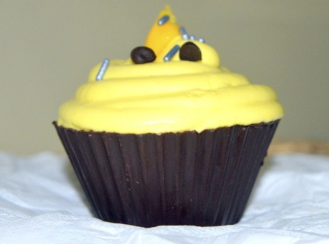 A mango mousse filled chocolate cup on a table.