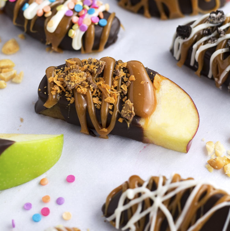 Caramel apples with other toppings sprinkled on.