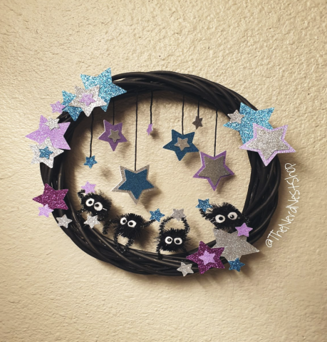 Studio Ghibli spiders on a wreath of purple and blue stars and dark twine.