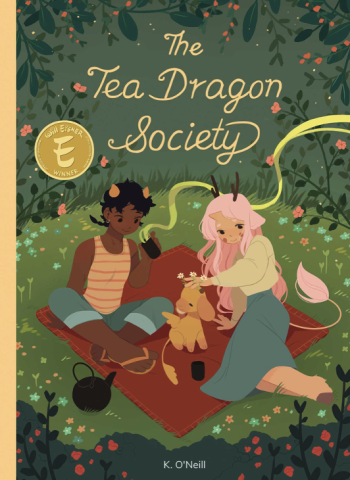 The Tea Dragon Society book cover, two girls on a picnic blanket are on the cover.