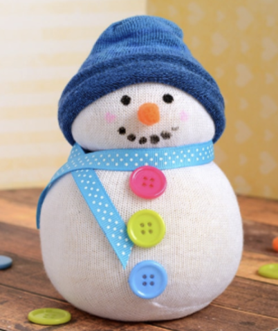 A snowman made of a sock, with a blue hat, light blue scarf, and pink, green and blue buttons.