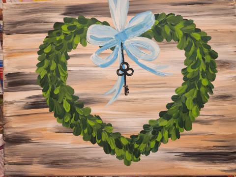 Image of a painted canvas featuring a heart with a bow and key. 