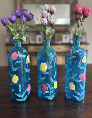 Image of 3 painted vases with dried flowers. 
