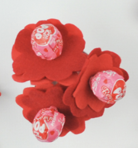 A bouquet of pink tootsie pops in red felt flowers.
