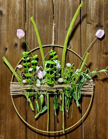 Image of the craft featuring a wood board with faux wild flowers attached with twine.