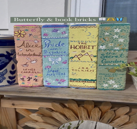 Garden Bricks painted in pastel colors with book spines painted on them, such as Alice in Wonderland, Pride and Prejudice, The Hobbit, and The Sweet Garden