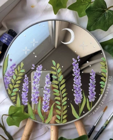 Mirror with lavender flowers painted on it as well as a white crescent moon and stars.