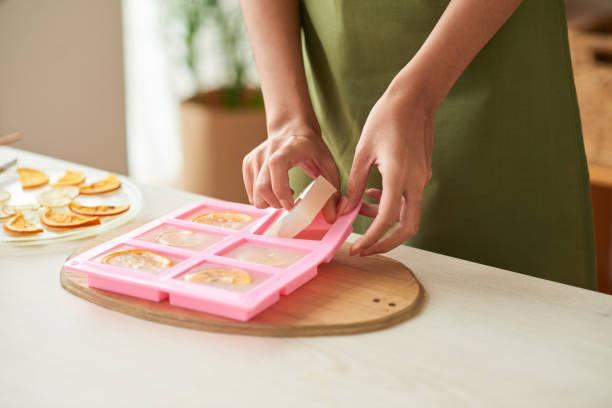 Image of person taking soap out of a mold.