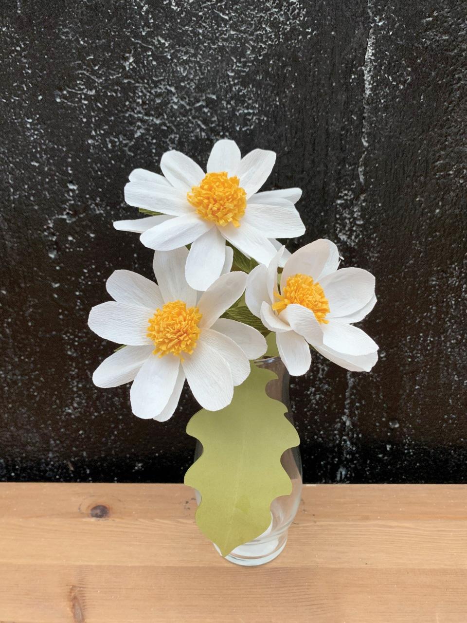 Image of 3 daisies made out of crepe paper. 