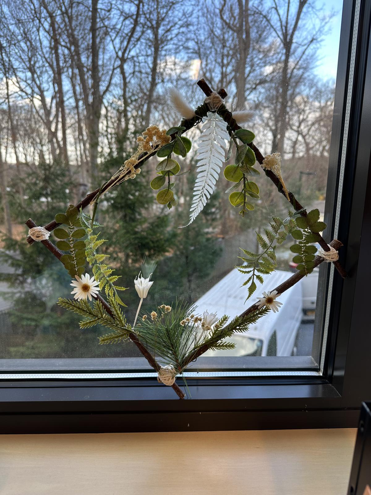Image of the craft featuring a vine square shaped wreath with silk flowers. 