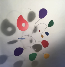 A hanging sculpture made of wire and thin multicolored rounded panels.