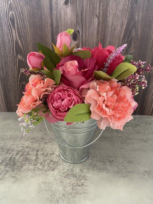 Image of the craft featuring different dried flower in a metal pail pot.