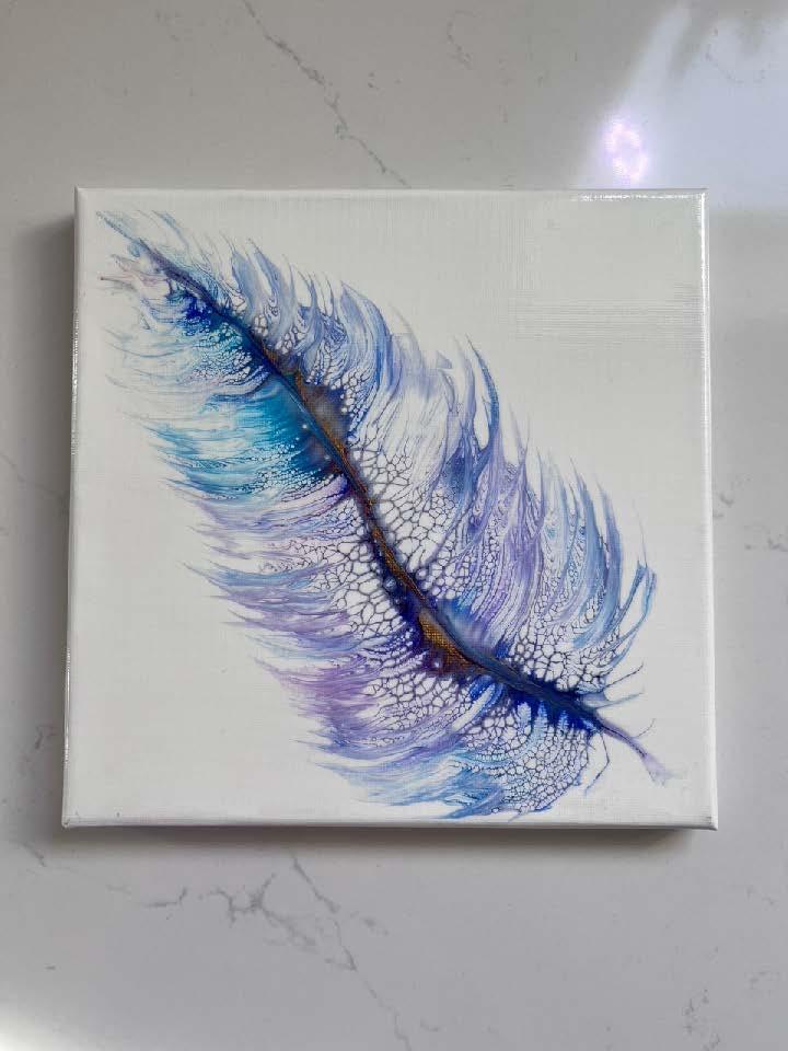 Image of the craft featuring a painted feather on a tile. 