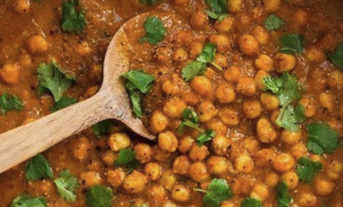 Chickpea Curry with a wooden spoon in it.