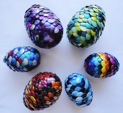 Multicolored dragon eggs on a white table, from an arial view. 