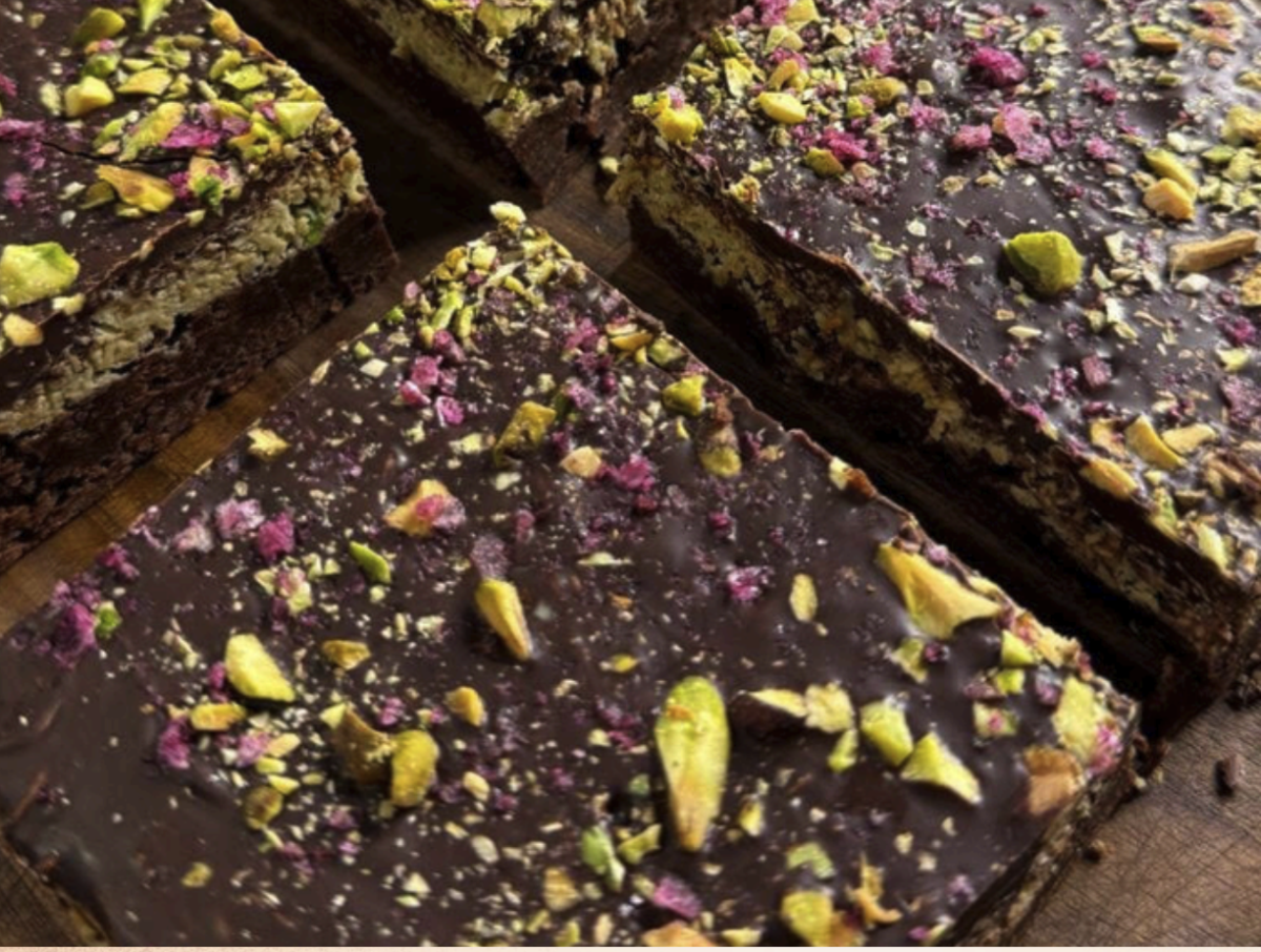 Image of chocolate brownies with sprinkled pistachios.
