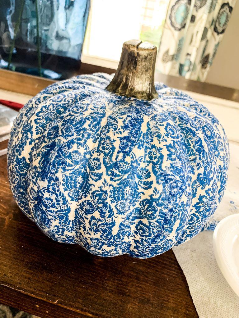 Image of the craft featuring a pumpkin shaped decoration with a decoupaged intricate design.