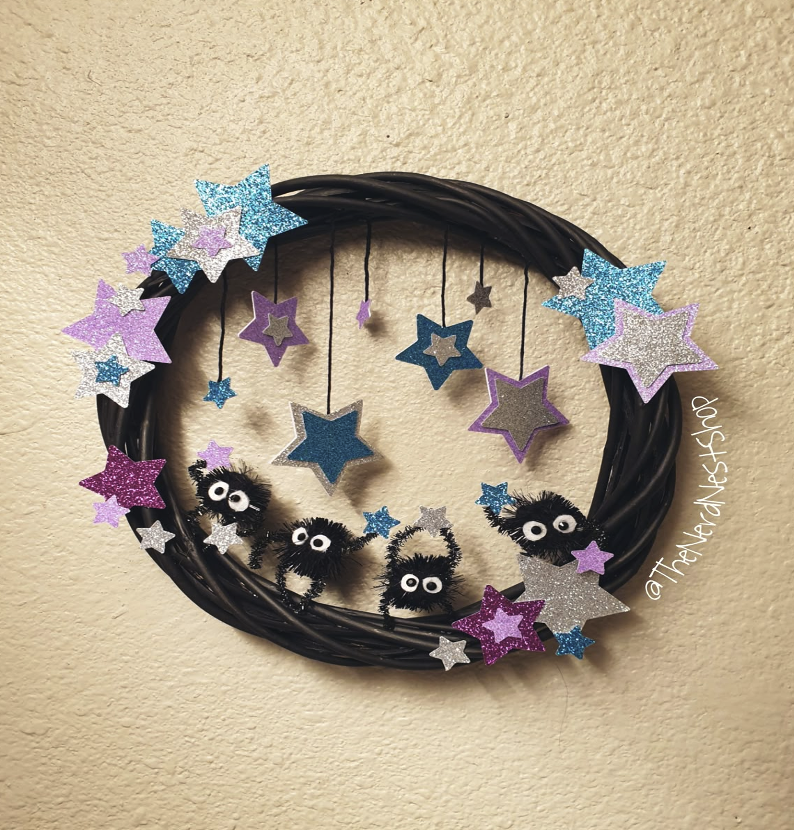 Studio Ghibli spiders on a wreath of purple and blue stars and dark twine.