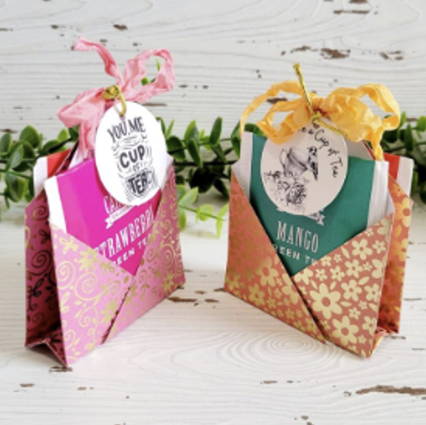 Two gift bags, one pink and one orange.