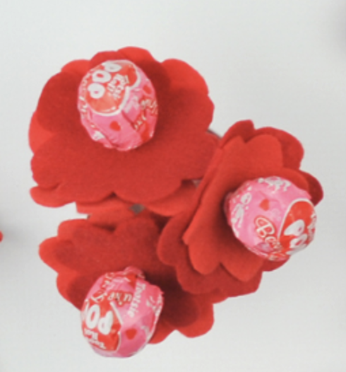 A bouquet of pink tootsie pops in red felt flowers.