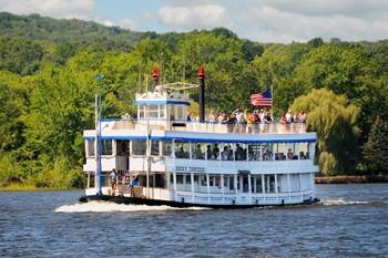Image of a river boat cruising on water. 