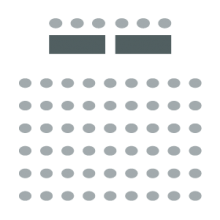 Rows of chairs facing speaker tables and chairs at front of room